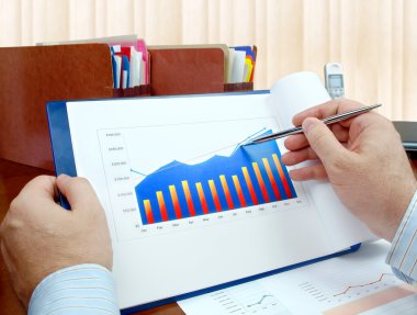 Analyzing investment charts. clipart