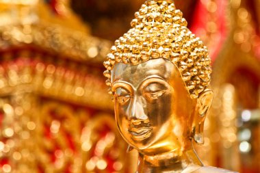 Gold face of Buddha statue in Doi Suthep temple, Chiang Mai, Thailand. clipart