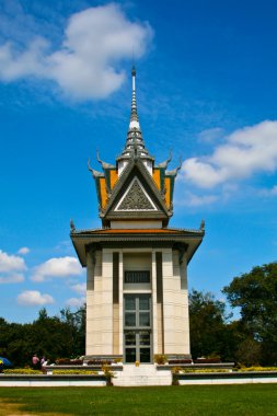 The memorial stupa of the Choeung Ek Killing Fields filled with the skulls clipart