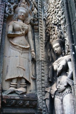 Detail of stone Apsara (Devata) carving in Angkor Wat complex clipart