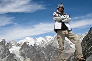 Climber standing on the top of Kongma La pass with mountain range of Khumbu clipart