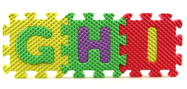 Alphabet puzzle pieces — Stock Photo, Image