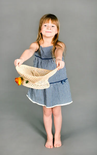 Little girl in a dress with a straw hat — Stock Photo, Image