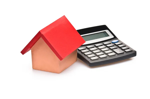 Red roofed house over white with calculator — Stock Photo, Image
