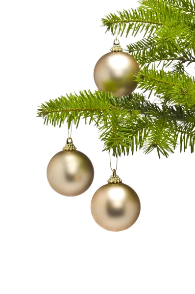 Três bolas de decoração dourada no ramo da árvore de Natal — Fotografia de Stock