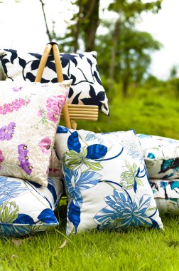 Beautiful pillow displayed on lawn in a garden clipart