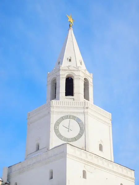 stock image White clock tower against the blue sky.