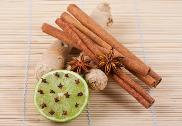 Ginger root, anise, cinnamon, lime and cloves — Stock Photo, Image