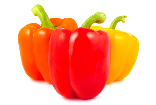 Orange, red and yellow peppers on a white background — Stock Photo, Image