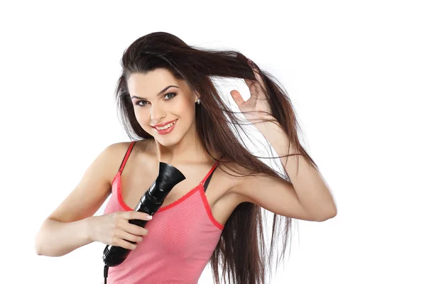 Jovem, bela morena com um secador de cabelo — Fotografia de Stock