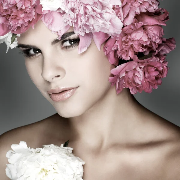 Vacker ung flicka med rosa blommor — Stockfoto