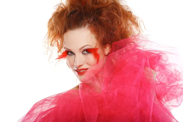 Beautiful redheaded girl with red feathers — Stock Photo, Image