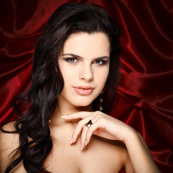 A beautiful young woman is in red clothes Stock Picture