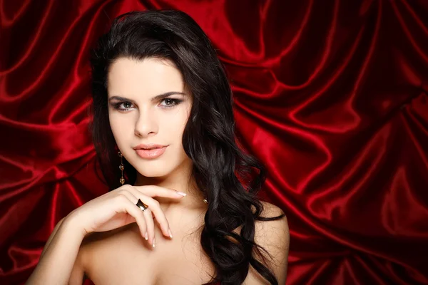 A beautiful young woman is in red clothes Stock Picture