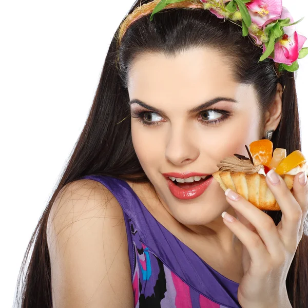 Young, beautiful brunette with fruit cake isolated on white — Stock Photo, Image