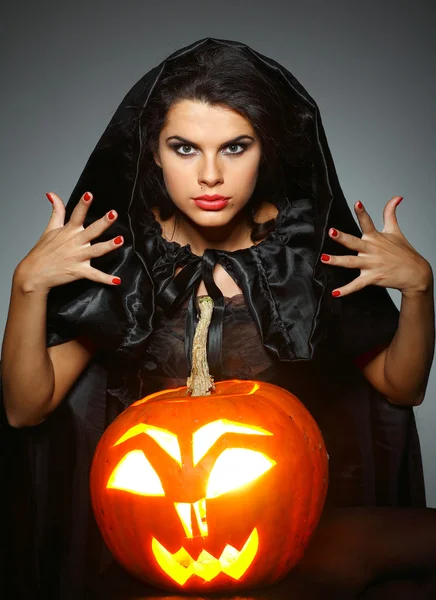 Sexual brunette in the suit of witch in night of Halloween Stock Photo