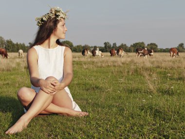 Girl sitting on grass meadows clipart