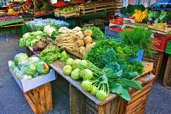 Киоски со свежими овощами и фруктами на рыночной площади — стоковое фото