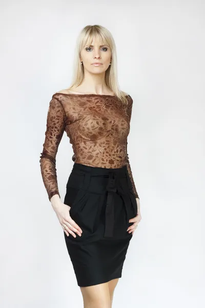 Beautiful blond woman in black mini skirt — Stock Photo, Image