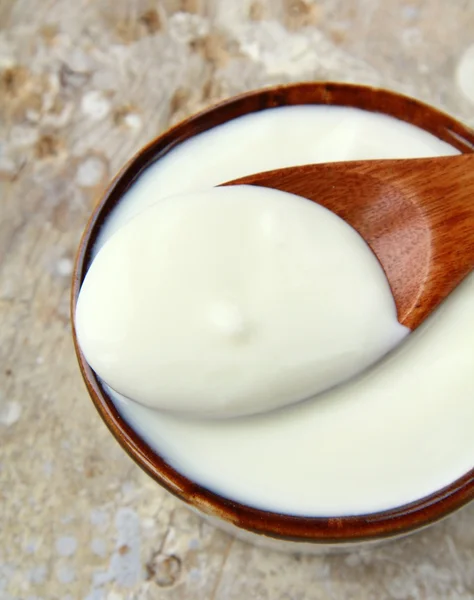 Frischer Naturjoghurt im Keramikbecher auf Holztisch — Stockfoto