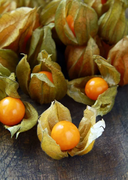 stock image Yellow organic physalis on a wooden board