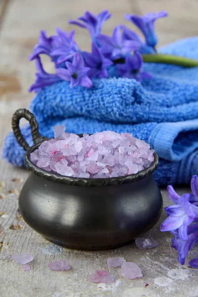 Spa still life .Bath lilac salt, towel and flowers — Stock Photo, Image