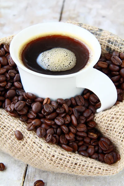 Cup of black coffee and coffee beans — Stock Photo, Image