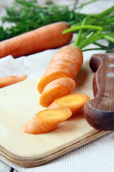 Fresh sliced carrots on a wooden board — Stock Photo, Image