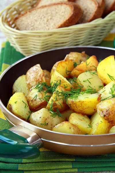 Fresh potatoes fried in a pan with dill — Stock Photo, Image