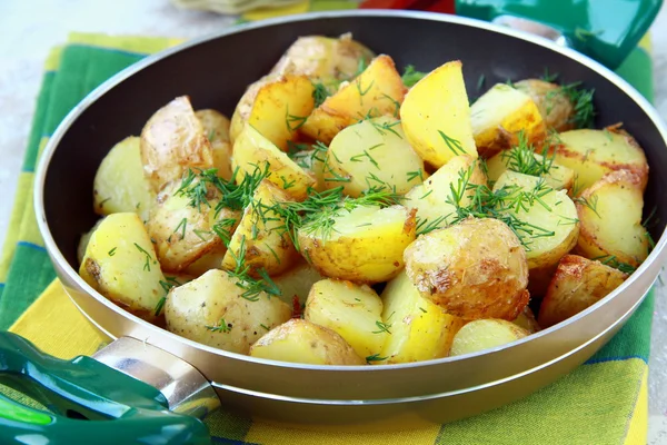 Fresh potatoes fried in a pan with dill — Stock Photo, Image