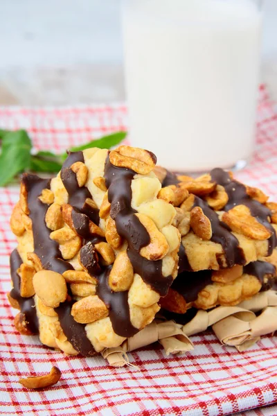 Homemade cookies with chocolate and nuts and a glass of milk — Stock Photo, Image