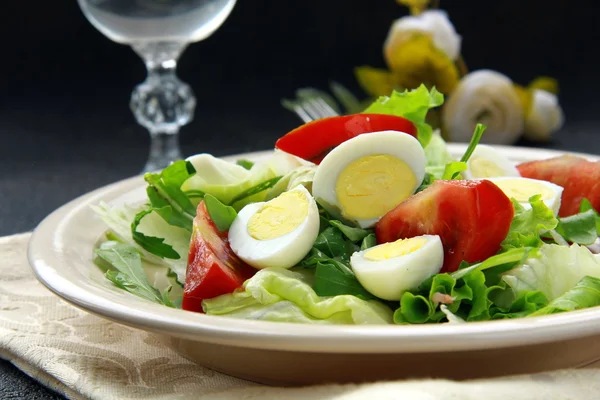 Salada com ovos de codorna e rúcula em placa bege fundo preto — Fotografia de Stock