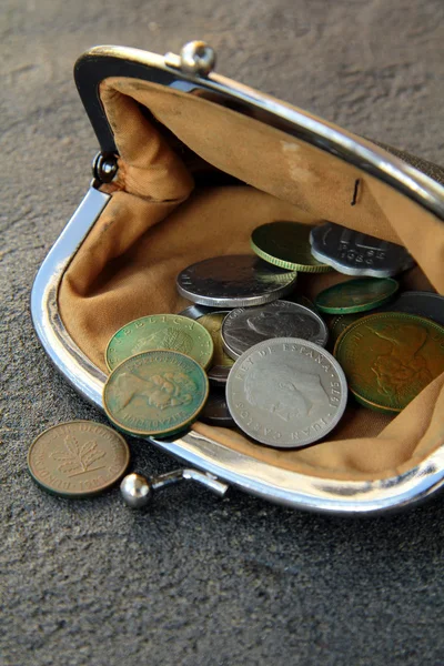 Ancient coins in the open vintage purse on a black background — Stock Photo, Image