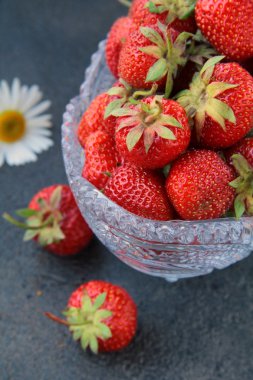 Antique glass vase with fresh tasty strawberries clipart