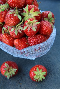 Antique glass vase with fresh tasty strawberries clipart