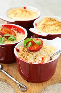 Crumble plum dessert with mint in a cup