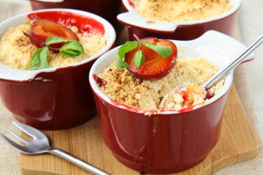 Crumble plum dessert with mint in a cup