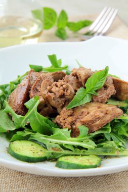 Salad appetizer with chicken liver, arugula and cucumber clipart