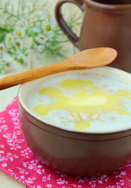 黄油在木桌上一碗麦片粥 — 图库照片