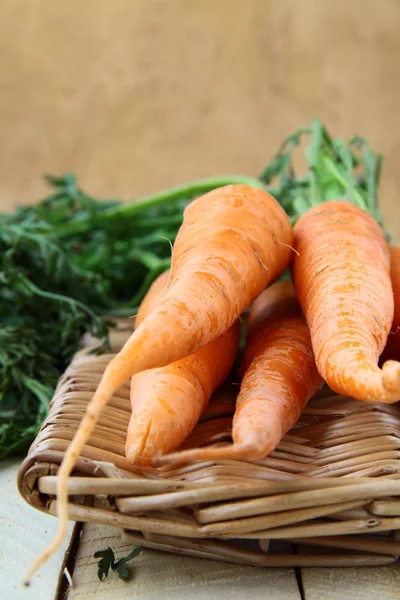 Fresh baby carrots in a wicker basket — Stock Photo, Image