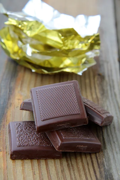 Chocolate with a shiny open gold cover — Stock Photo, Image
