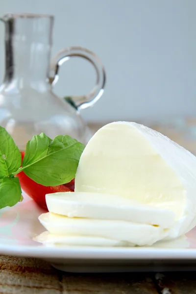 Italian mozzarella cheese with tomato and basil — Stock Photo, Image
