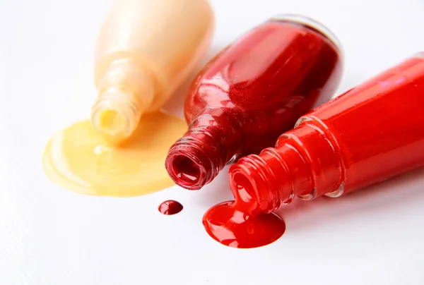 stock image Multi-colored nail polish for hands spilled on a white background