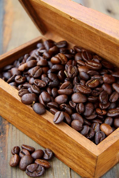 Flavored coffee beans in a wooden brown box — Stock Photo, Image