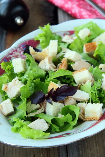 Sezar salatası kruton ve ahşap bir masa üzerinde tavuk — Stok fotoğraf
