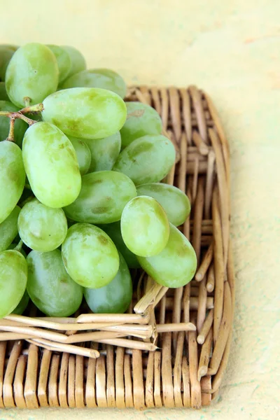 Branch of green grapes on a wooden background — Stock Photo, Image