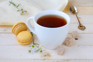 Cup of fragrant tea with sugar and sweets clipart