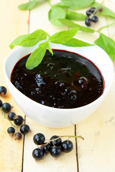 stock image Black currant jam with mint leaves