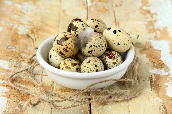 Ovos de codorna em uma tigela em uma mesa de madeira — Fotografia de Stock