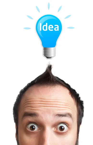 Funny young man with light bulb over his head — Stock Photo, Image